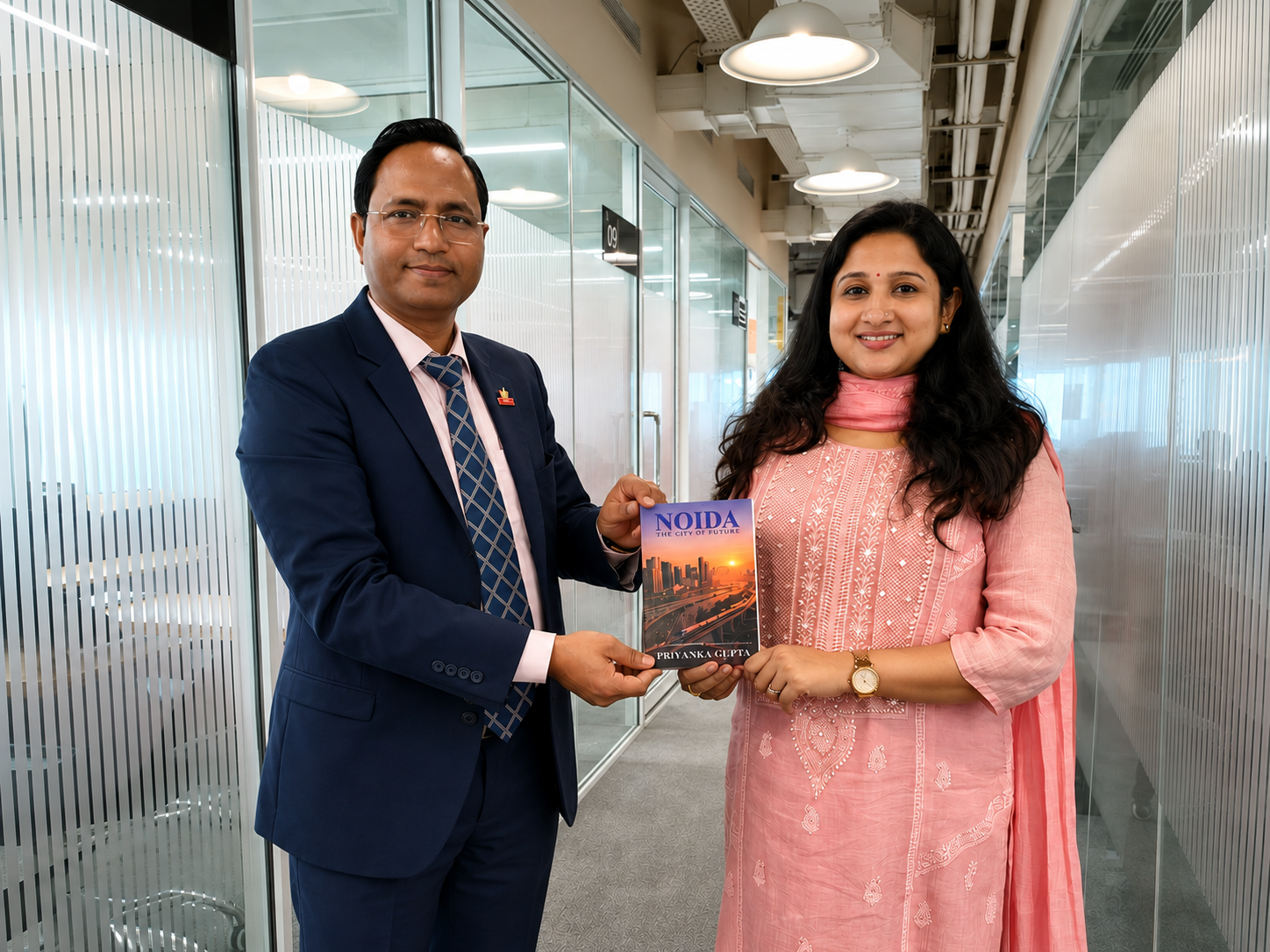 Priyanka Gupta presenting her book 'Noida' to Mr. Chandrashekhar Singh, Founder of MYNDOZ Corporation